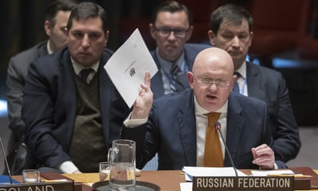The Russian ambassador to the UN, Vassily Nebenzia, holds up a British report on the Salisbury nerve agent attack at the security council meeting on the case.