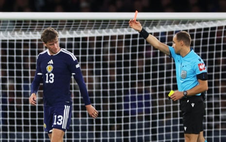 Scotland's Jack Hendry is shown a red card by referee Nenad Minakovic.