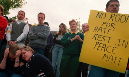 A friend of Matthew Shepard, who was murdered in 1998 in an apparent gay hate crime, holds a sign in support in Denver, Colorado on 12 October 1998.