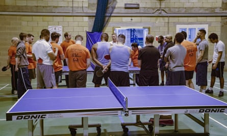 High Down prisoners and volunteers from Brighton Table Tennis Club gather in the prison gym after a session.