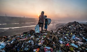 Children looking through rubbish on landfill siteCalcutta (Kolkata), India. Neoliberal policies have led to social and environmental failures.