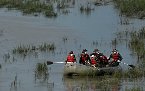 Army personnel conduct a search and rescue operation for flood victims along the Narayani river at Bharatpur in Nepal's Chitwan district.