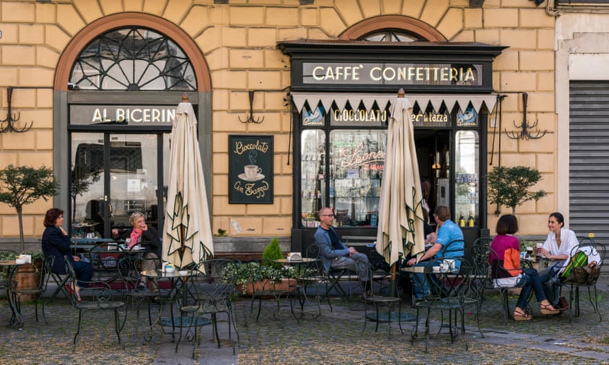 People seated at tables outiside the historical Caffe Al Bicerin in Turin