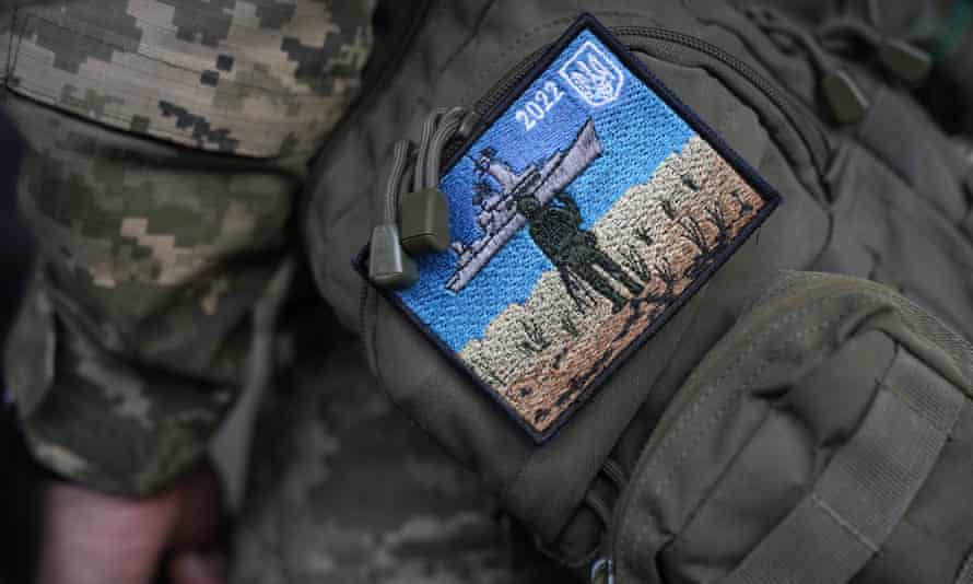 A Ukrainian soldier in Kyiv wears a “Snake Island” embroidered badge on his uniform commemorating the moment when a Ukrainian soldier defiantly replied “Russian warship, go f*ck yourself!’ when ordered to surrender.