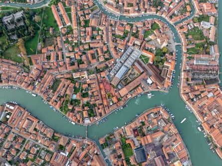 Aerial image of picturesque canals and colourful rooftops in Murano, a historic old town in Venice.