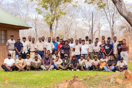A large group of people pose for a photograph outside