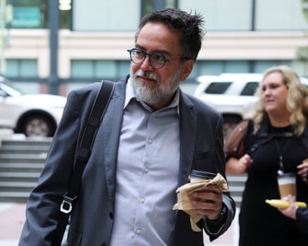 Arturo Béjar wears a blue suit and holds a coffee.