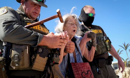 Ced Franklin is assisted by sheriff officers before being evacuated after Hurricane Ian caused widespread destruction in Matlacha, Florida.