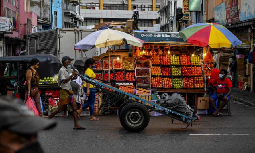 A fruit vendor waits for customers in Colombo