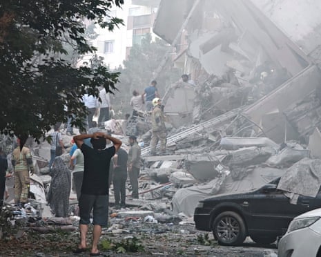 People survey the damage in Nobonyad Square, Tehran