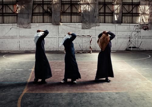 Young women in jilbab exercise in a gym in Gaza.