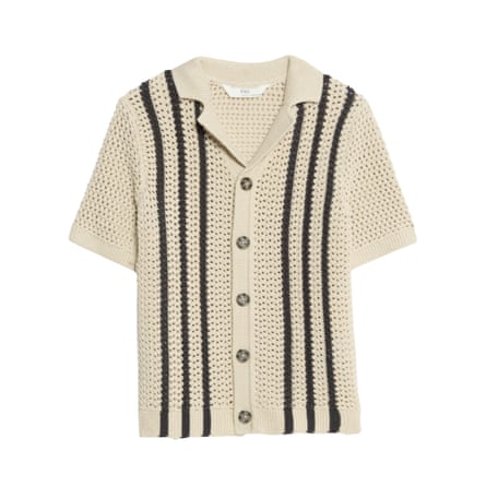 A beige cotton knitted shirt with three black vertical stripes on either side of the brown buttons