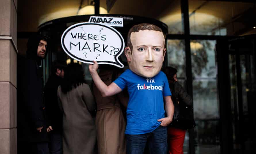 A protester wearing a papier-mache Mark Zuckerberg head outside Portcullis House in November 2018.