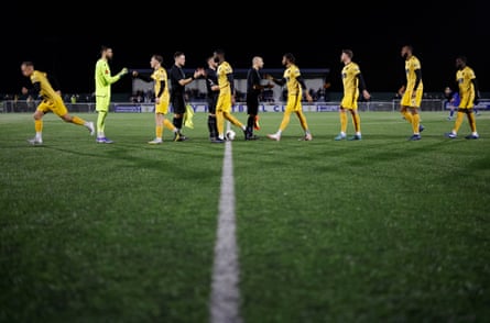 Maidstone players shake hands with the officials before kick-off at Aveley during the week.
