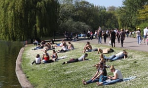 People enjoy the sun in Regent’s Park, London