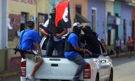 NICARAGUA-UNREST-PARAMILITARIES<br>Paramilitaries are seen on a truck at Monimbo neighborhood in Masaya, Nicaragua, on July 18, 2018, following clashes with anti-government demonstrators. The head of the Inter-American Commission on Human Rights has described as "alarming" the ongoing violence in Nicaragua, where months of clashes between protesters and the forces of President Daniel Ortega have claimed almost 300 lives. / AFP PHOTO / MARVIN RECINOSMARVIN RECINOS/AFP/Getty Images