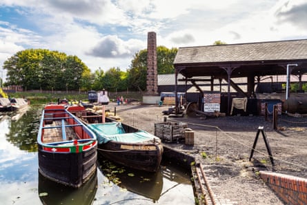 Canal boats, dock and a forge on a canalside at the Black Country Living Museum