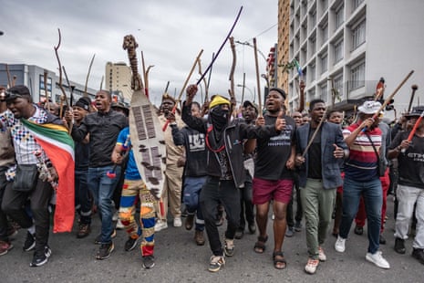 A group of protesters in Durban, South Africa holding clubs and bats