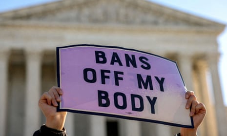 A person holds a sign reading 'bans off my body' outside the US supreme court.
