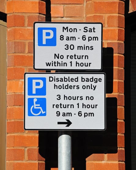 Parking restrictions signs showing the times for both abled and disabled drivers