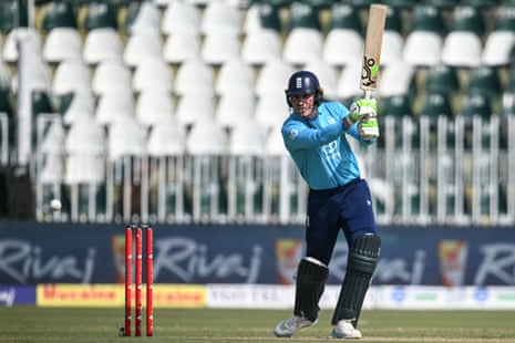 England's Tom Banton swings his bat during an ODI match, with empty stadium seating behind