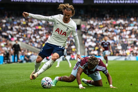 Tottenham’s James Maddison rides an Aston Villa tackle,
