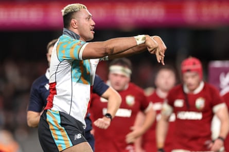 Rob Leota makes an M with his hands while celebrating scoring a try against the Lions