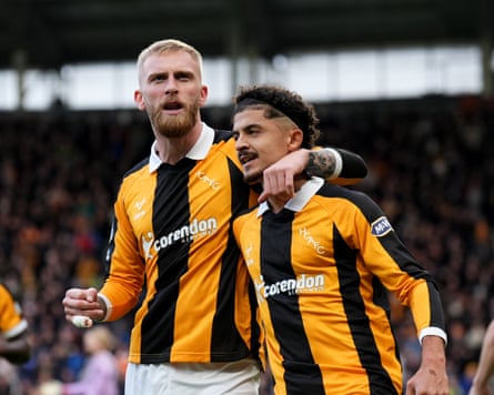 Oli McBurnie (left) hugs Mohamed Belloumi after putting Hull ahead from the penalty spot