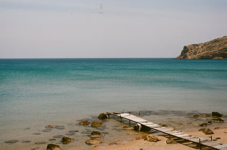 A wooden jetty off a beach