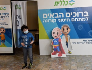 An Israeli boy walks in a Clalit vaccination center after receiving a Pfizer-BioNTech Covid-19 vaccine in Jerusalem on 17 December 2021.
