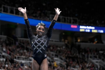 Simone Biles waves to the crowd after completing her floor exercise on Sunday to clinch her eighth US championship.