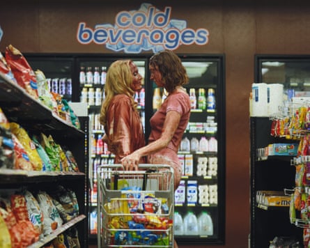 Two women in grocery store gazing into each other’s eyes