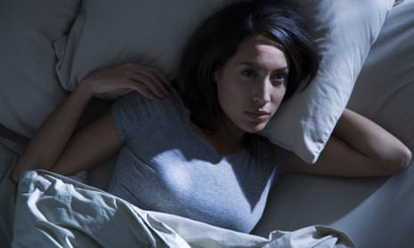 Woman awake in bed in the dark