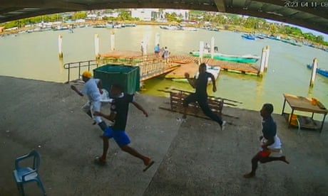 ECUADOR-CRIME-DRUG TRAFFICKING-DEATH<br>Handout frame grab from CCTV video footage in Esmeraldas' Artisanal Fishing Port showing people running after armed men fired on the port in Esmeraldas, Ecuador on April 11, 2023. - Nine people were killed this Tuesday in Ecuador by some thirty armed attackers who arrived in boats and cars at a port for artisanal fishermen in the northern province of Esmeraldas, on the border with Colombia, authorities reported. (Photo by Handout / Security camera in Esmeraldas' Artisanal Fishing Port / AFP) / RESTRICTED TO EDITORIAL USE - MANDATORY CREDIT "AFP PHOTO / SECURITY CAMERA IN ESMERALDAS' ARTISANAL FISHING PORT" - NO MARKETING NO ADVERTISING CAMPAIGNS - DISTRIBUTED AS A SERVICE TO CLIENTS (Photo by HANDOUT/Security camera in Esmeraldas' A/AFP via Getty Images)