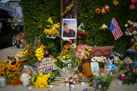 Flowers surround a photo of a young man.