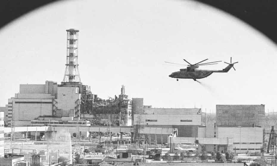 A helicopter on a run to  drop material into the opening in the roof of the damaged Chernobyl reactor, 1986. Photograph: Igor Kostin, Sputnik Images