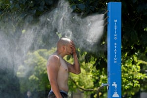 Vancouver, Canada: A man cools off at a misting station during the scorching weather.