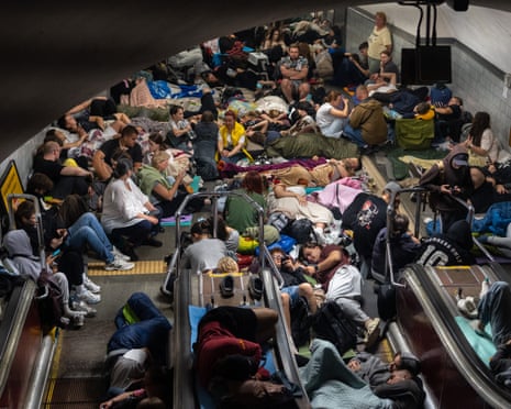 People take shelter at a metro station during Russian missile strike on Kyiv.