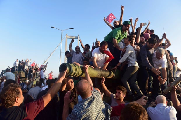 Anti-coup protesters take over a tank abandoned on the Bosphorus Bridge in Istanbul.