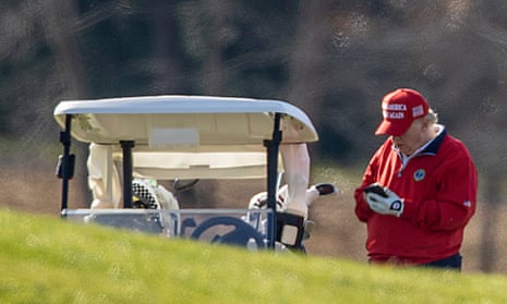 Donald Trump uses his mobile phone while on his golf course in Sterling, Virginia.