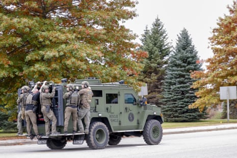 A police tactical unit makes its way down a street during the search for mass-shooting suspect Robert Card in Lisbon Falls, Maine, USA, 26 October 2023.