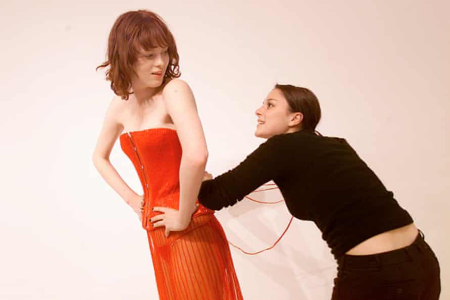 Model Karen Elson having her corset adjusted before the Victoria’s Secret 2001 lingerie show