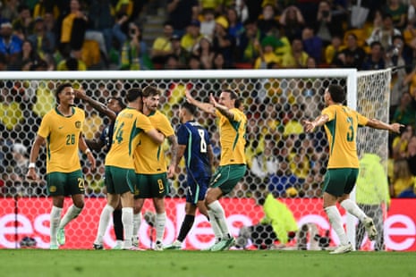 The Socceroos get aroundConnor Metcalfe after his goal.