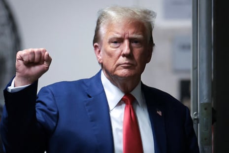 Donald Trump makes a fist bump to reporters but, unusually, does not speak outside the New York courthouse on Monday where is on trial for falsifying business records.