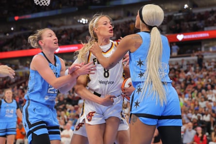 Indiana’s Sophie Cunningham (center) reacts to DiJonai Carrington’s hard foul during Saturday’s game.