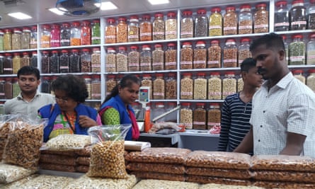 Mumbai blue squad searches a shop for plastic bags.