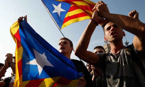 Pro-independence protesters hold Catalan flags in Barcelona