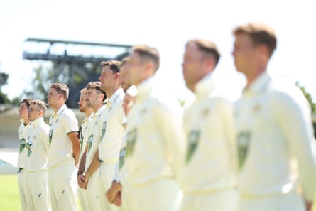 Cameron Green of the Prime Ministers XI sings the national anthem in the team lineup before day one of the Test
