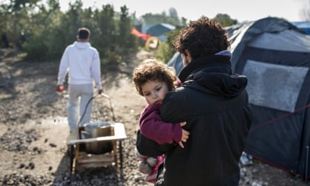 A young man and his infant child in the camp