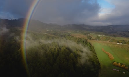 Aerial view of Orokonui Ecosanctuary on New Zealand’s south island, with mist and a rainbow above it.